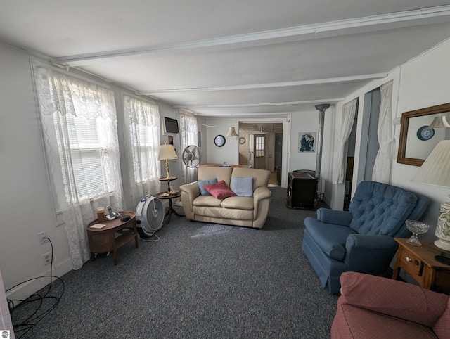 living room with dark carpet, ornate columns, and beamed ceiling