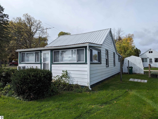 view of side of home featuring a lawn