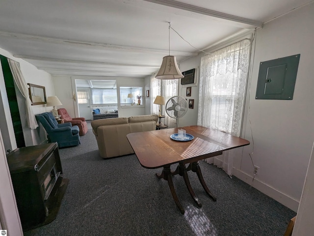 carpeted dining room with beamed ceiling