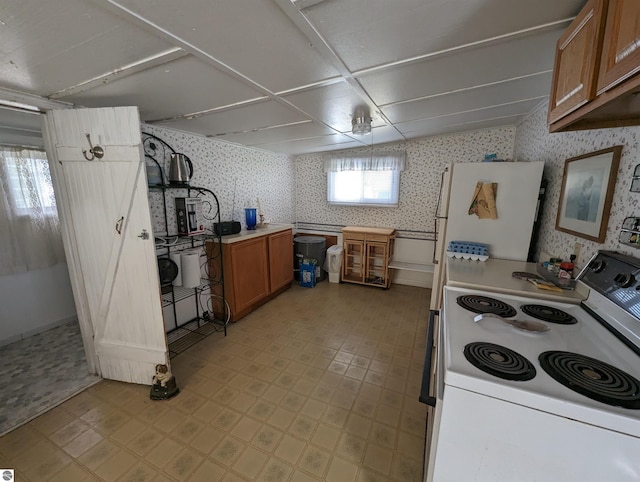 kitchen featuring white appliances and light tile flooring