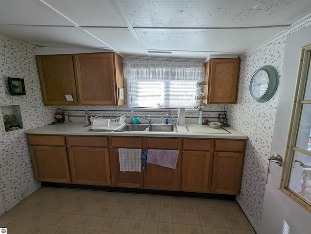 kitchen featuring light tile floors and sink