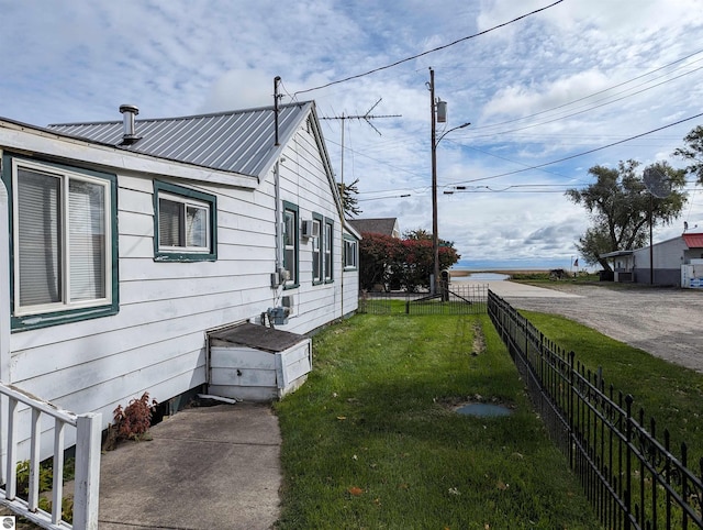 view of side of home with a lawn