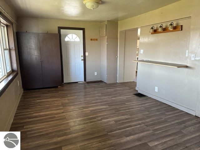 spare room with dark wood-type flooring