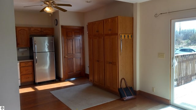 kitchen with light hardwood / wood-style flooring, ceiling fan, and stainless steel fridge