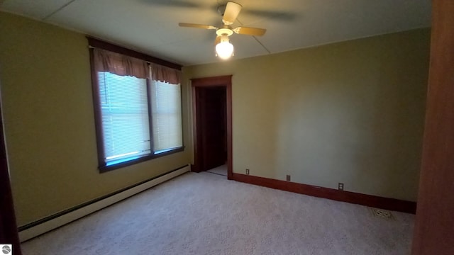 unfurnished room featuring ceiling fan, baseboard heating, and light carpet