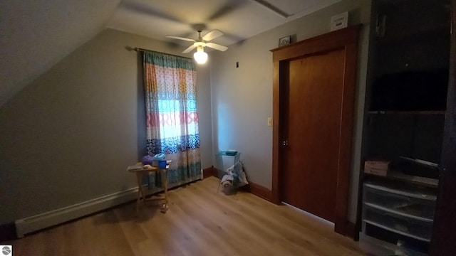 bonus room featuring vaulted ceiling, light hardwood / wood-style floors, and ceiling fan