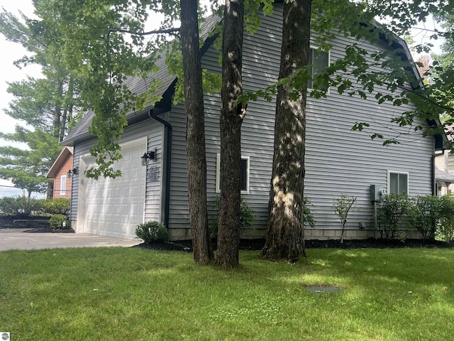 view of home's exterior featuring a yard and a garage