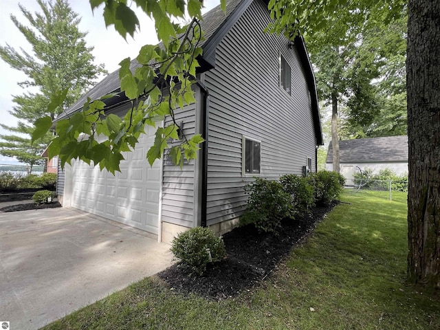 view of property exterior featuring a lawn and a garage