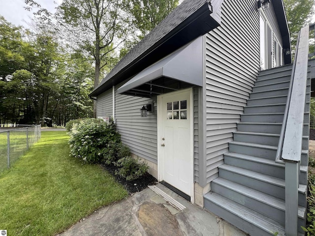 property entrance with a lawn