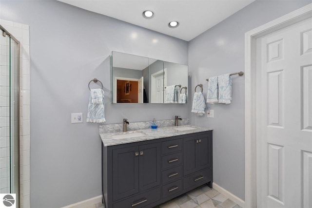 bathroom with a shower with shower door, dual bowl vanity, and tile flooring