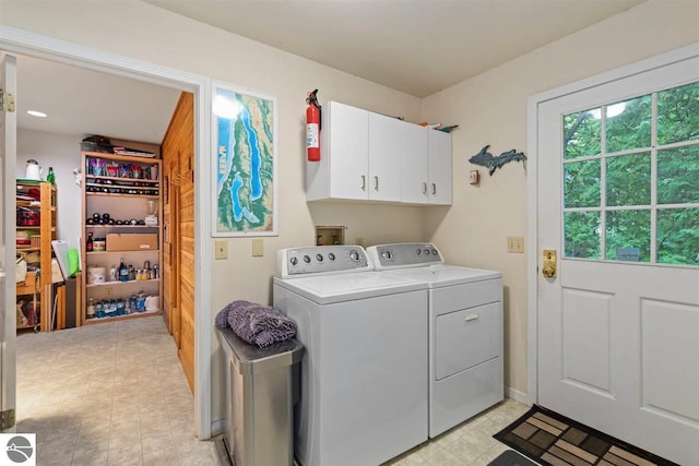 laundry area featuring separate washer and dryer, cabinets, light tile flooring, and hookup for a washing machine