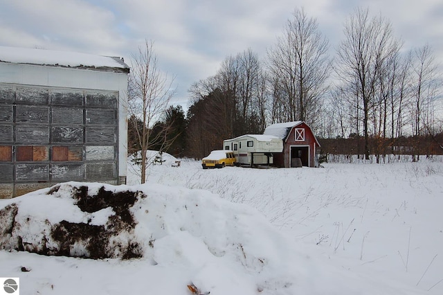 snowy yard with an outdoor structure