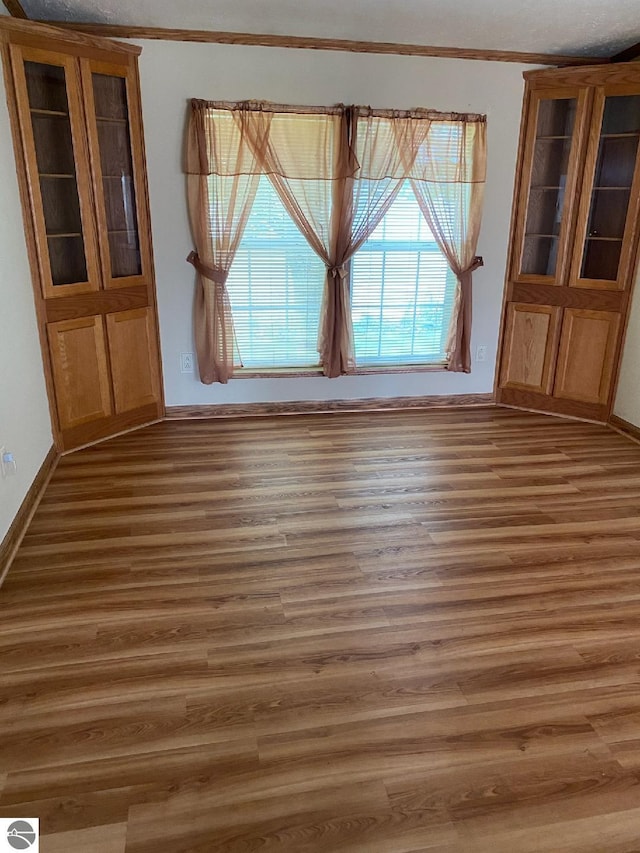 interior space featuring ornamental molding and wood-type flooring