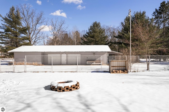 snow covered property with a fire pit