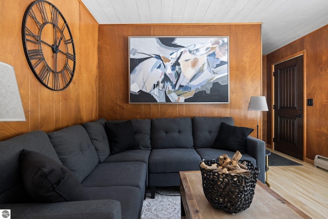 living room with wood walls and light wood-type flooring