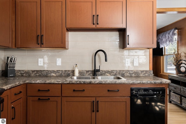 kitchen featuring tasteful backsplash, light hardwood / wood-style flooring, dishwasher, and sink