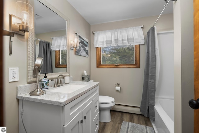 full bathroom with shower / bath combo, a baseboard heating unit, vanity, hardwood / wood-style flooring, and toilet