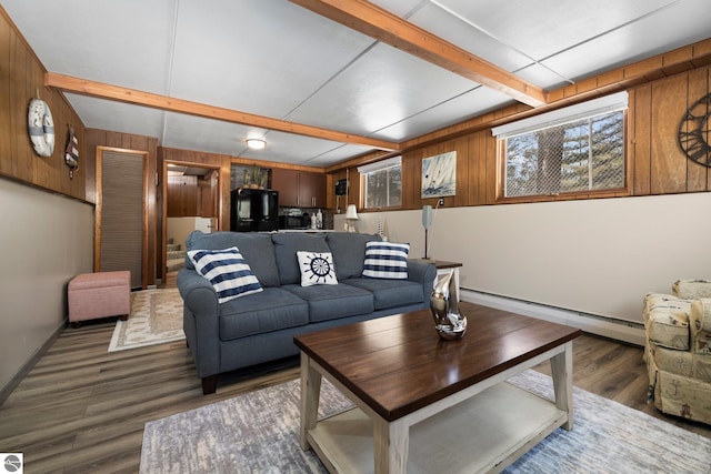 living room featuring wooden walls, dark hardwood / wood-style flooring, beamed ceiling, and a baseboard radiator