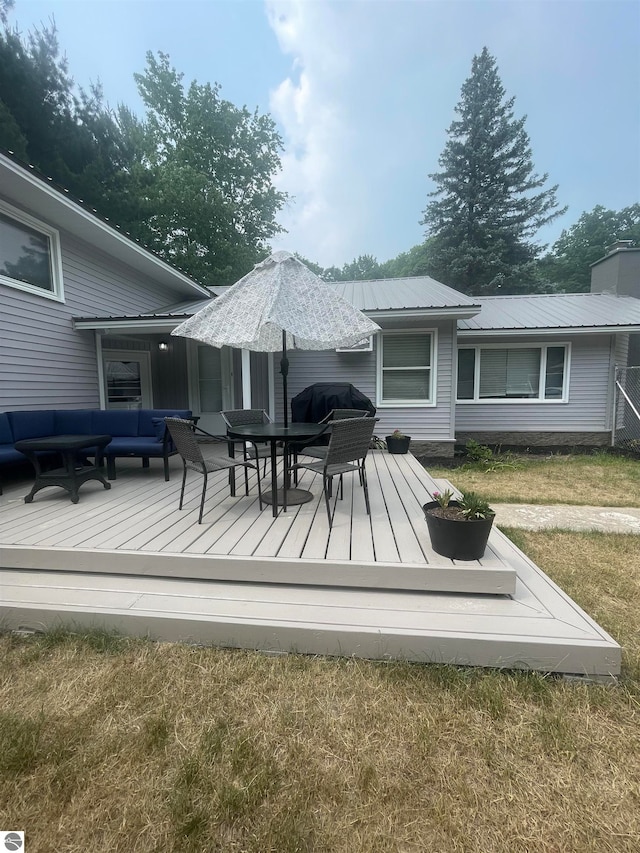 rear view of house with a wooden deck, an outdoor living space, and a yard