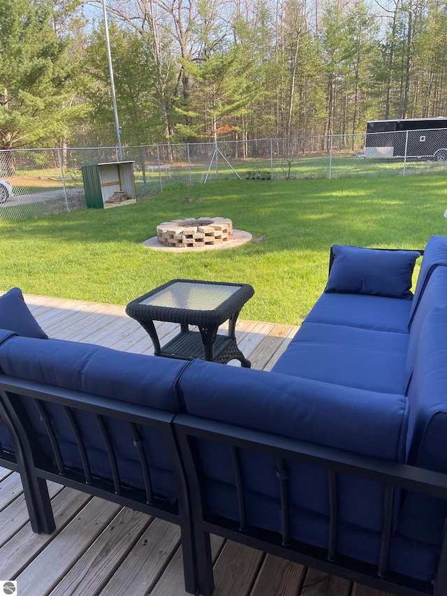 view of yard featuring a deck and an outdoor living space with a fire pit