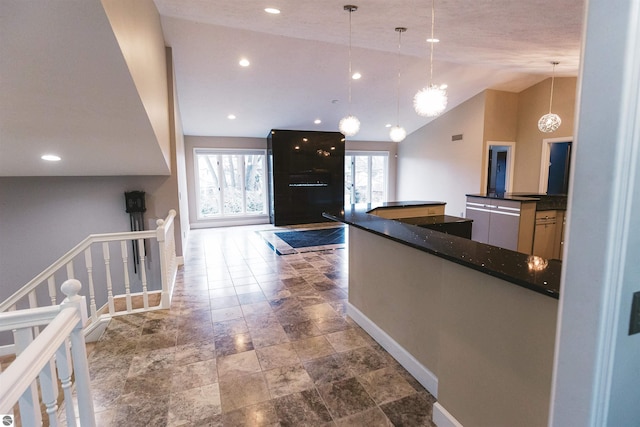 kitchen with decorative light fixtures, lofted ceiling, and a notable chandelier