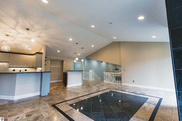 kitchen with pendant lighting, backsplash, high vaulted ceiling, and gray cabinetry