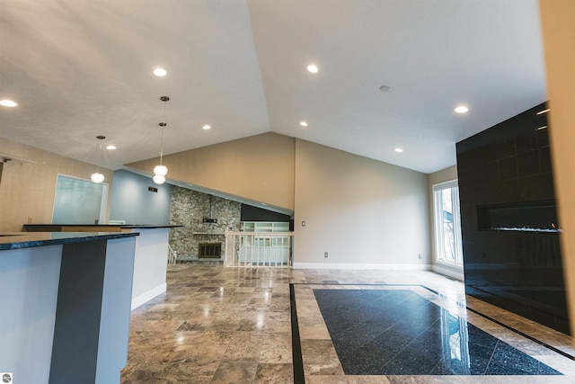 kitchen featuring a fireplace, high vaulted ceiling, and hanging light fixtures