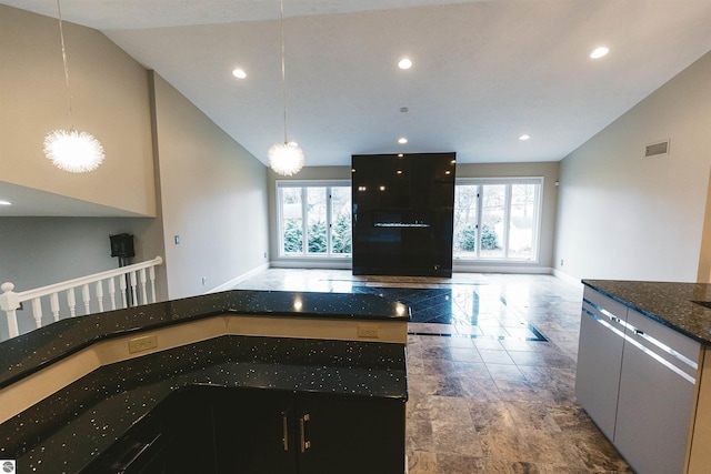 kitchen featuring plenty of natural light, a center island, hanging light fixtures, and high vaulted ceiling