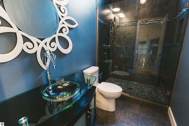 bathroom featuring vanity, toilet, and a shower with door