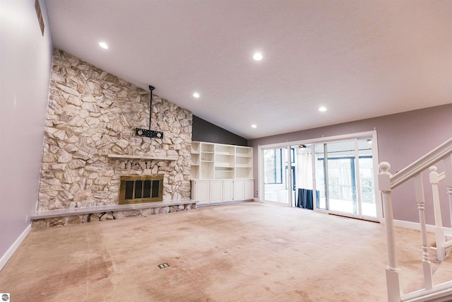 unfurnished living room featuring carpet flooring, a fireplace, and vaulted ceiling