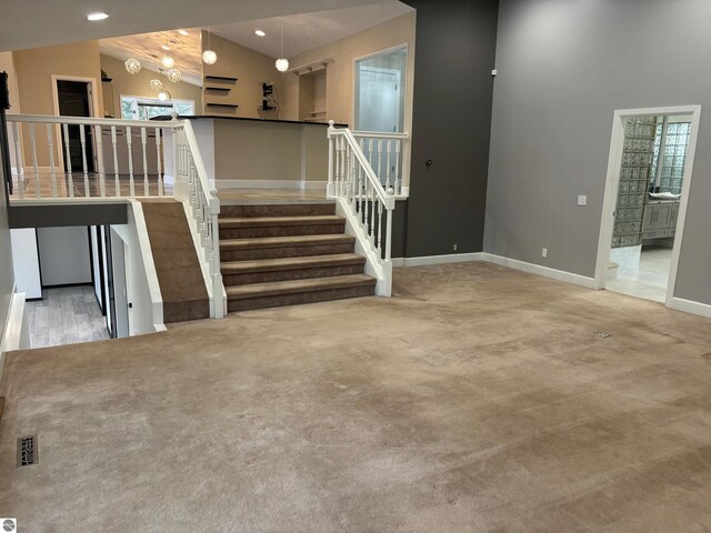 interior space with carpet floors and vaulted ceiling