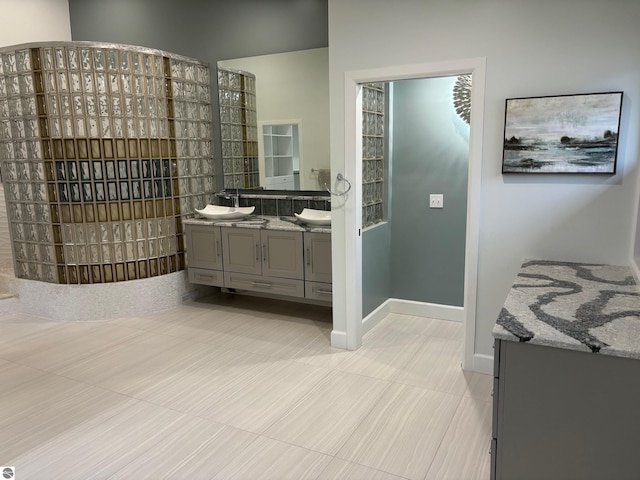 bathroom with tile patterned flooring and vanity