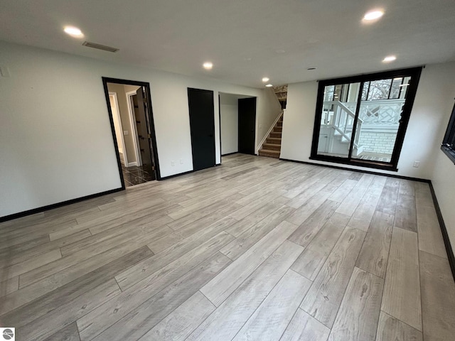 unfurnished room with light hardwood / wood-style flooring