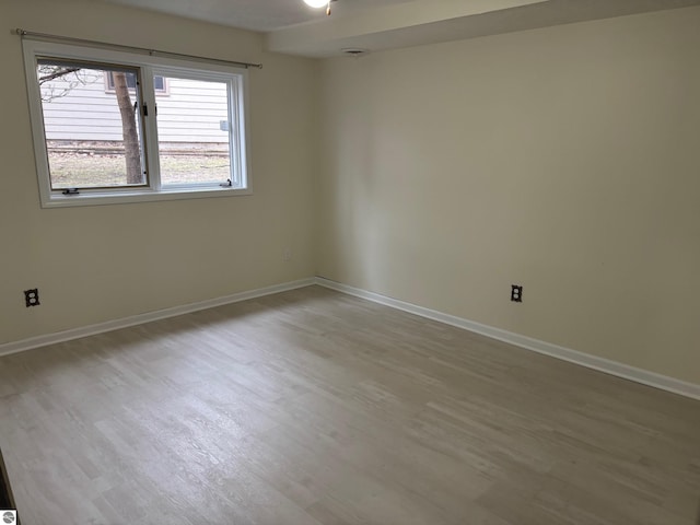 spare room with light hardwood / wood-style floors