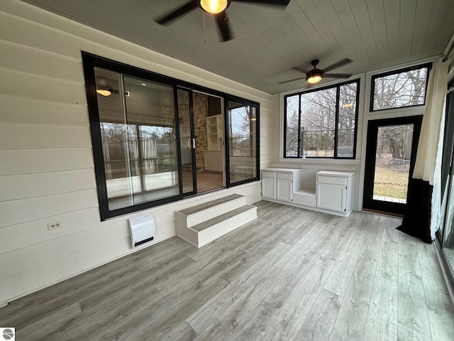 unfurnished sunroom with ceiling fan and wooden ceiling