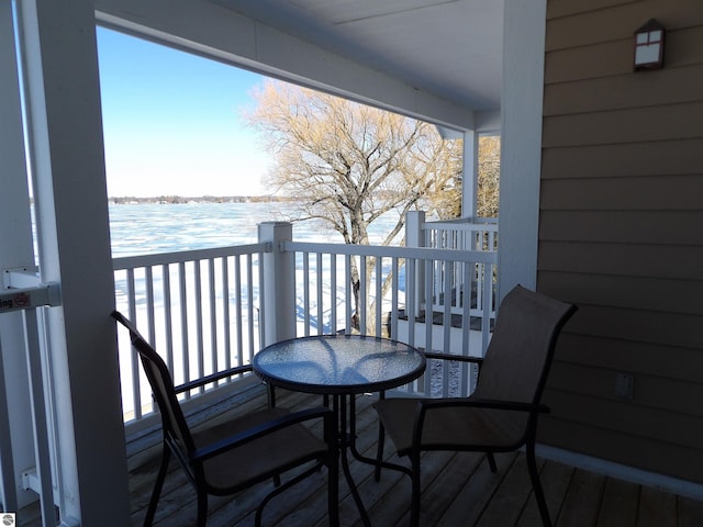 view of snow covered back of property