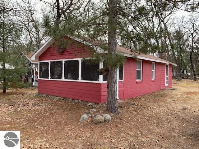 view of side of property featuring a sunroom