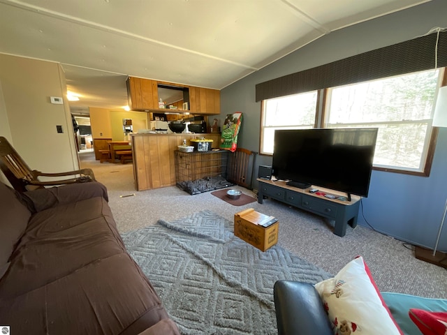 carpeted living room featuring lofted ceiling