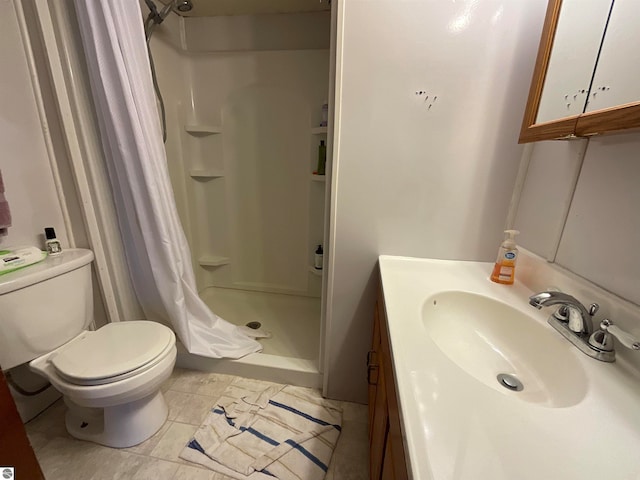 bathroom featuring curtained shower, tile flooring, oversized vanity, and toilet