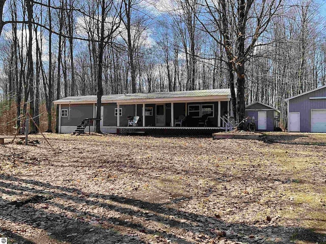 view of front of house with a garage and an outdoor structure