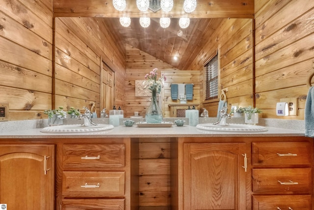 bathroom featuring wood walls, lofted ceiling, double sink vanity, and wood ceiling