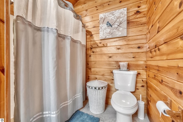 bathroom featuring wooden ceiling, wooden walls, toilet, and tile patterned floors