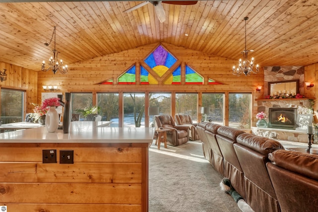 interior space featuring wood ceiling, carpet flooring, vaulted ceiling, and a stone fireplace