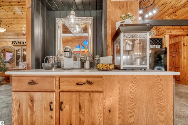 kitchen featuring light carpet, wood walls, and wooden ceiling