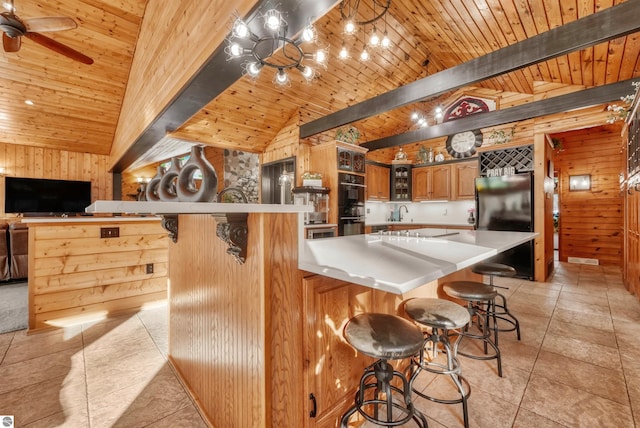 kitchen featuring lofted ceiling with beams, light tile patterned flooring, wooden ceiling, and a breakfast bar