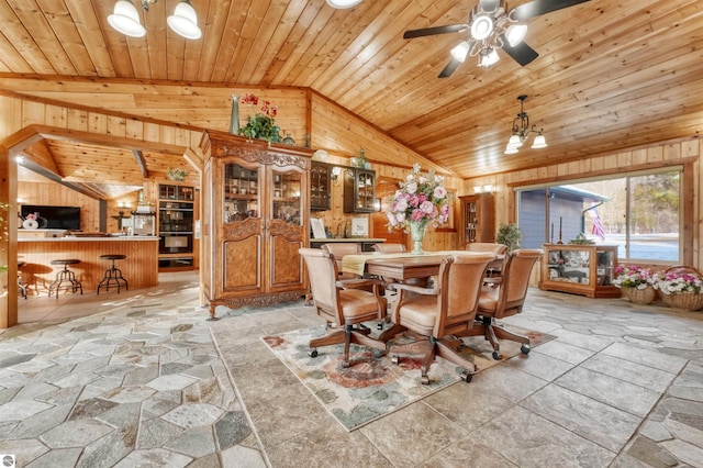 dining area with ceiling fan with notable chandelier, wooden walls, light tile patterned flooring, and wood ceiling