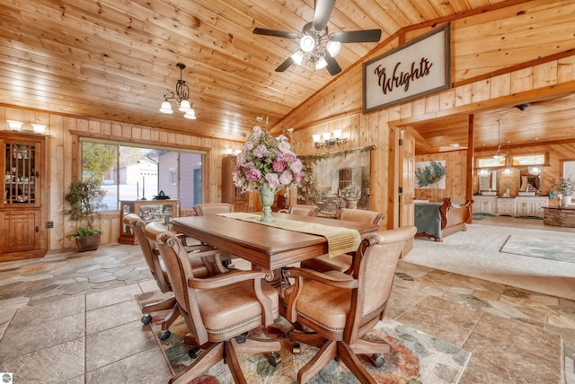 tiled dining area with ceiling fan, high vaulted ceiling, wood ceiling, and wooden walls