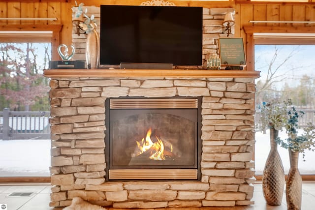 exterior details featuring tile patterned floors and a fireplace