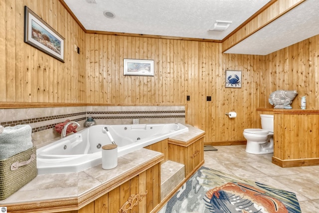 bathroom with wooden walls, a textured ceiling, and toilet