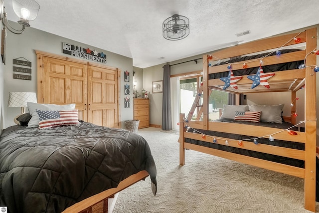 carpeted bedroom with a textured ceiling